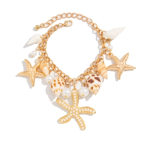 Detailed macro view of gold starfish, seashells and pearls on the marine waist chain