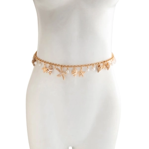 Detail of gold waist chain featuring starfish, shell pendants and pearls on a white mannequin