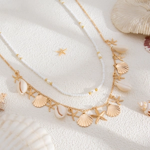 Ocean style gold waist chain with sea shells, starfish charms and white beads for beach