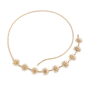 Detailed macro view of golden sun face pendants on a metallic layered body chain belt