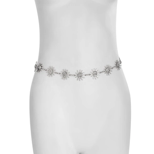 Detail shot of silver sunface pendants on a bohemian metal waist chain for women