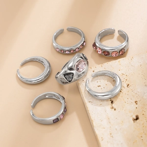 Detail van zilveren ringenset met kleurrijke roze en paarse kristallen edelstenen