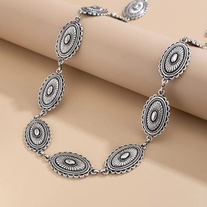 Detailed close-up of vintage silver waist chain with intricate bohemian floral engravings
