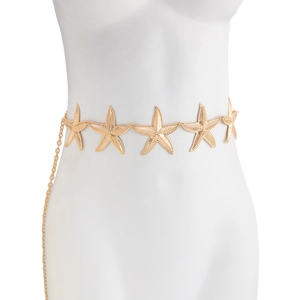 Close-up of golden starfish body chain showing textured metal details on a white mannequin