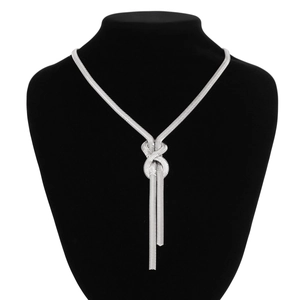 Detail of silver snake chain necklace featuring a unique metal knot and tassel drops