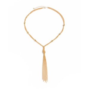 Detail of gold metal knot tassel necklace featuring multiple chains and bead accents