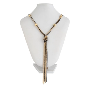 Detail view of long Y-shaped tassel necklace with knot design and metallic beads