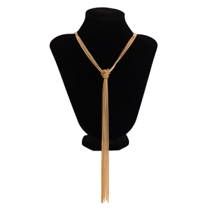 Detail of gold layered chain necklace with knot design and long tassels on black bust