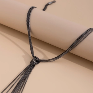 Macro shot of gunmetal multi-strand chain necklace with elegant tassel knot detail
