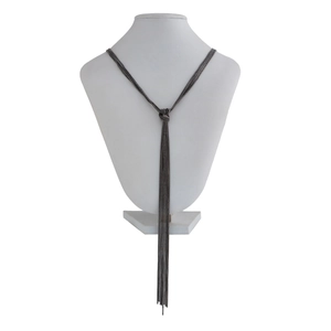 Detail of multi-layer tassel knot necklace in gunmetal finish on a jewelry bust