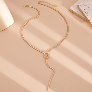 Macro detail of golden snake chain necklace with elegant knot and Y-shaped drop pendant