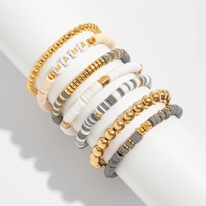 Detail of multi-layer Bohemian bracelets with gold MAMA beads and Heishi disks
