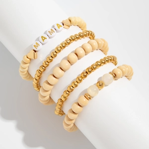 Detail of bohemian wooden bead bracelet set with golden MAMA letter beads