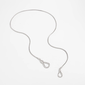 Macro view of minimalist silver snake chain with polished horseshoe-shaped clasps