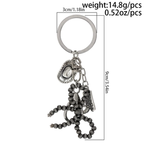 Détail du porte-clés chapeau et botte de cowboy avec dimensions 9cm par 3cm et spécifications