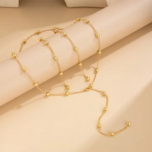 Minimalist gold bead chain necklace for women with long tassel fringe and bright metallic finish