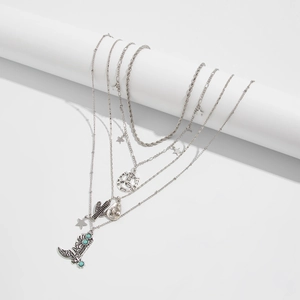 Macro detail of western retro necklace set with cactus and cowboy boot turquoise pendants
