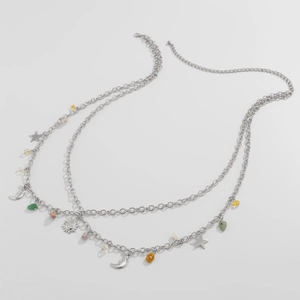 Detailed shot of bohemian silver waist chain with star, moon, sun charms and colorful stones