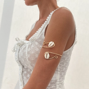Golden wire wrap arm cuff with natural white shells for beach bohemian style