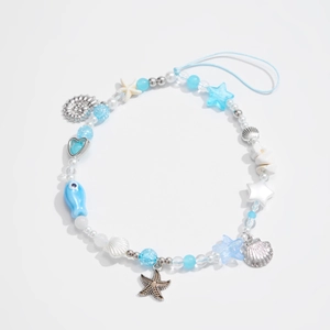 Détail du bijou de téléphone thème océan avec étoiles de mer, coquillages et perles