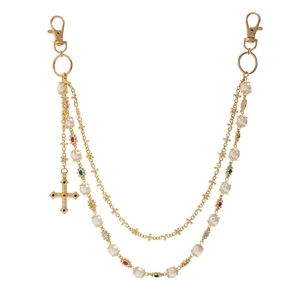 Detailed view of multilayer gold chain with imitation pearls and colorful crystal cross