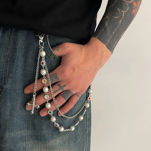 Detail of multi-layer trousers chain with pearls, colorful rhinestones and cross pendant