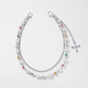 Detail of silver chain with faux pearls, colorful crystal snowflake beads, and cross pendant