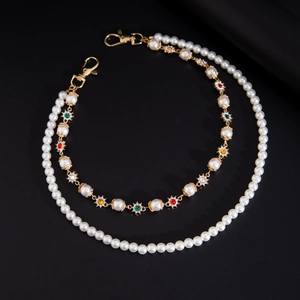 Detail of beaded pant chain with colorful crystal flowers and gold lobster clasps