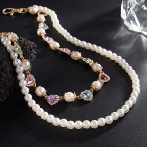 Macro detail of double-layer pearl chain with colorful heart-shaped rhinestone charms