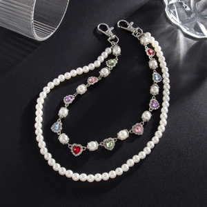 Detail of pearl chain with colorful rhinestone heart charms and silver lobster clasps
