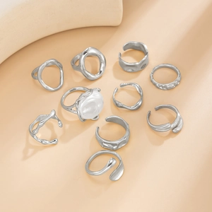 Set of 10 minimalist silver irregular metal rings and a single white pearl accent ring