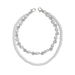 Detail of double-layer pearl chain featuring silver clover charms and lobster clasps