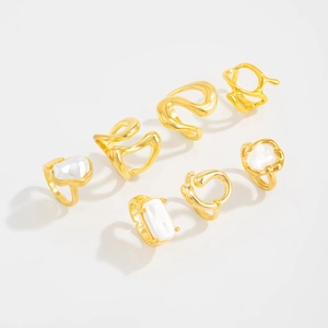 Detail view of 7-piece gold-plated ring set with irregular lines and baroque pearls