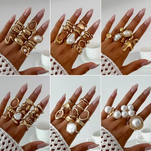 Golden irregular metal rings set with imitation pearls in a multi-piece fashion style