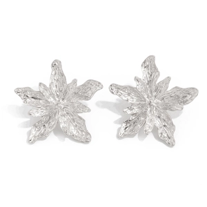 Detailed close-up of silver lava-textured flower earrings with metallic liquid finish