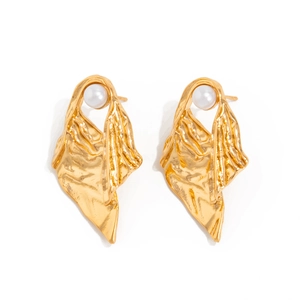 Detailed close-up of wrinkled gold metal earrings with a glossy white pearl accent