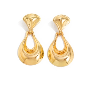 Detail of vintage gold teardrop earrings with irregular molten metal texture