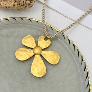 Detailansicht des großen goldenen Fünf-Blatt-Blumenanhängers mit gehämmerter Metallstruktur