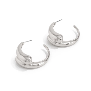 Close-up of silver lava-style teardrop earrings with a polished high-gloss mirror finish