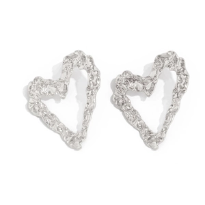 Close-up of silver liquid lava textured heart earrings with irregular metallic folds