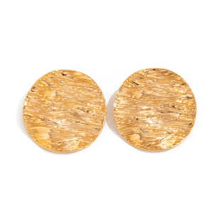 Macro shot of gold liquid lava metal earrings featuring irregular wavy texture details