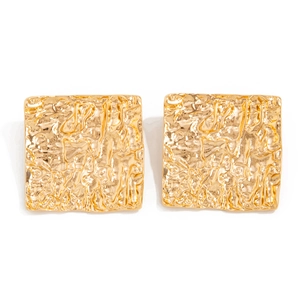 Close-up of golden square stud earrings featuring a liquid lava hammered metal texture