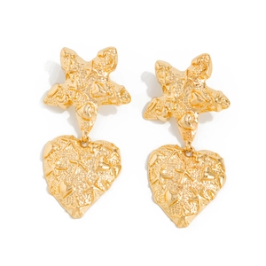 Detail view of golden starfish and heart stud earrings with embossed relief texture