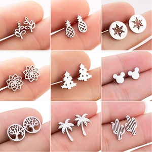 Macro view of nine stainless steel stud earrings featuring leaf and pineapple shapes