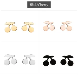 Detailed view of cherry-shaped metal studs in gold, rose gold, silver, and black colors
