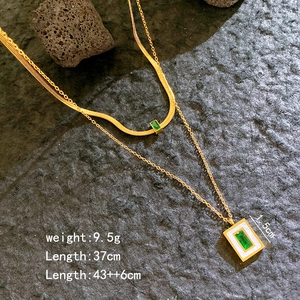 Elegant gold double layer necklace featuring square green gemstones and white shell accents