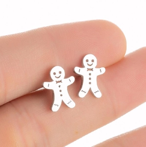 Minimalistische silberne Lebkuchenmann Ohrstecker aus Edelstahl auf der Fingerspitze