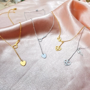 Minimalist stainless steel necklace collection featuring stethoscope and heartbeat heart pendants