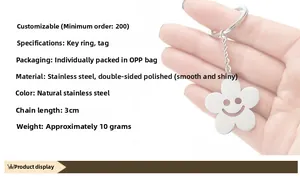 Detail of stainless steel smiley flower keychain held in hand with 3cm chain and ring