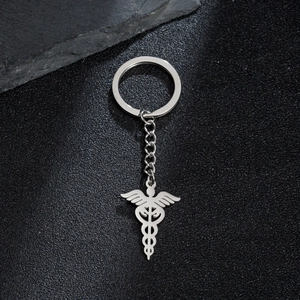Vintage stainless steel keychain featuring a medical caduceus pendant on a black stone background